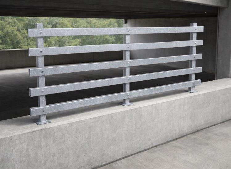 Yellow steel safety barrier installed in a parking garage