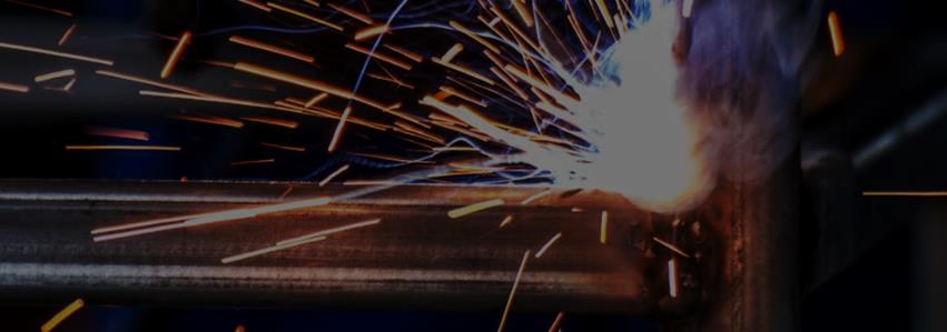 Close-up of precision welding sparks on a steel joint